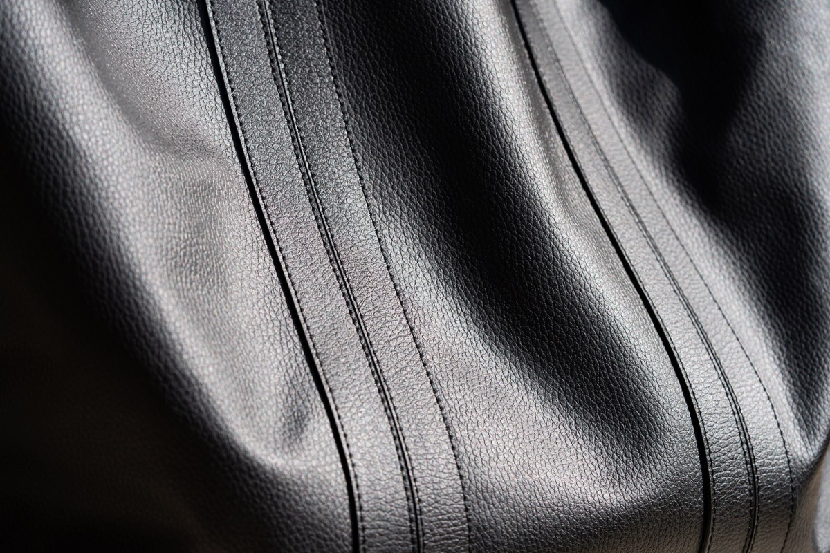 Textured black bio-leather with visible stitching